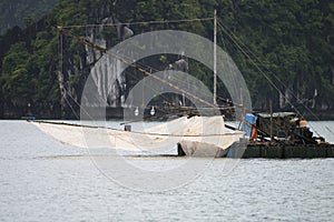 Fisherman boat in wonderful landscape of Ha long Bay, Vietnam