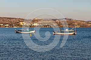 Fisherman boats in a bay in Milos photo