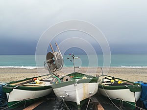 Fisherman boats on a beach in Liguria under cloudy sky