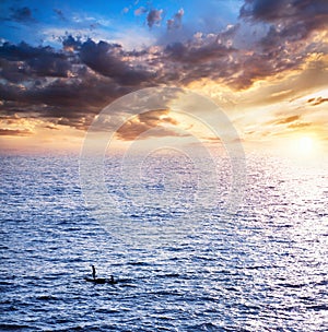 Fisherman boats catching fish at sunset