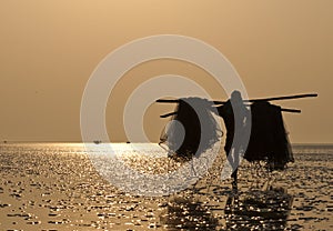 Fisherman carrying fishing net.