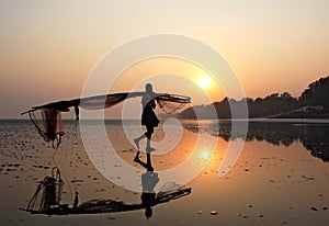 A fisherman carrying fishing net in a sea beach