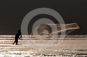 Fisherman casting fishing net