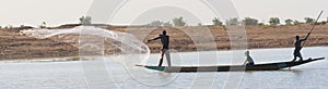 Fisherman casts a net on the Niger River, Mali.