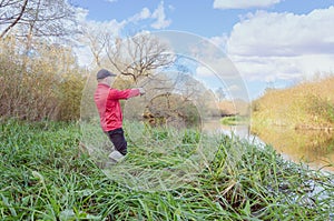 Fisherman casts a spinning rod into the river