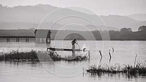 fisherman catch fish by wood stick at bang phra reservoir