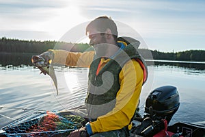 Fisherman catched a haddock in the sea