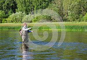 Fisherman catches of chub fly fishing in the Chusovaya river