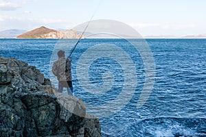 Fisherman catches fish on the sea