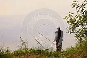 The fisherman catches on the lake at dawn.