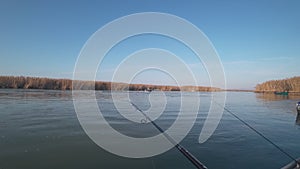 Fisherman catches predatory fish from a boat on a spinning on a river, first person view