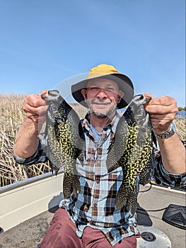 Fisherman Catching Crappie Panfish Out of Boat