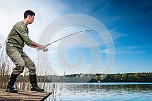 Fisherman catching fish angling at the lake photo