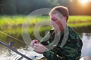 Fisherman catching fish on the lake from boat. Nature.