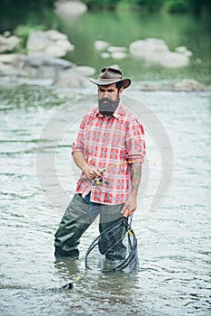 Fisherman caught a fish. Man fishing on river.