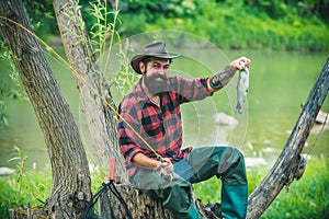 Fisherman caught a fish. Man fishing on river.