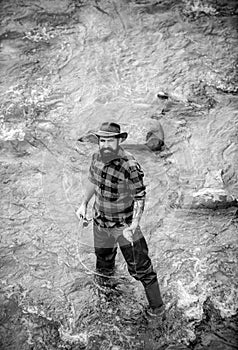 Fisherman caught a fish. Man fishing on river. Fisher man in water catching fish, top view.