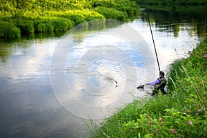 Fisherman caught fish on the river in the countryside.