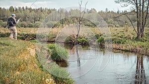 Fisherman caught a fish on a small river. Fishing with tenkara