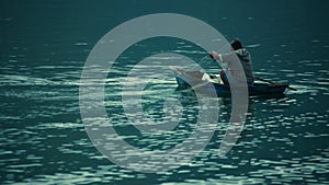 A fisherman is checking his net for fishes in Samosir Island, Toba Lake, North Sumatra, Indonesia.