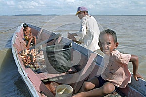 Fisherman, children and fish, Galibi, Surinam