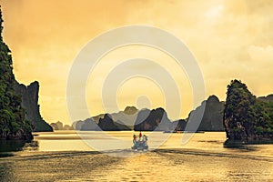Fisherman coming home in sunset at Halong bay, the most beautiful bay on the world