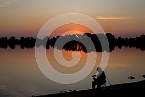 Fisherman at dawn fishing on a fishing rod