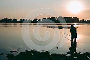 Fisherman at dawn fishing on a fishing rod