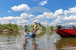 Fisherman fallen out from fishing boat. Flight of fisher after fall