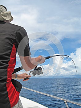 Fisherman fighting a fish