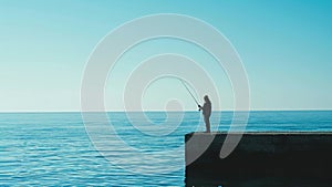 Fisherman with a fish on blue sea background.