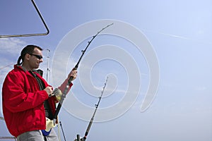 Fisherman fishing on boat big game tuna