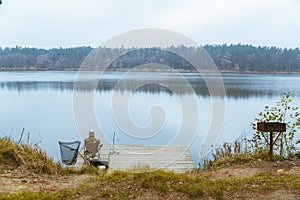 fisherman fishing at calm autumn lake