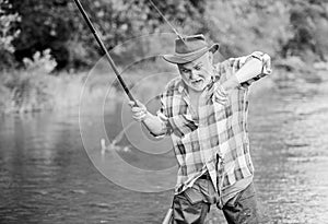 Fisherman fishing equipment. Fisherman alone stand in river water. Hobby sport activity. Fish farming pisciculture
