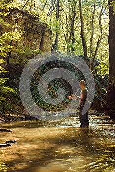 A fisherman fishing with fly fishing