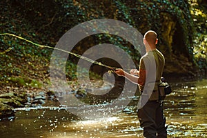 A fisherman fishing with fly fishing