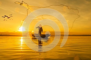 Fisherman fishing at lake in Morning, Thailand.