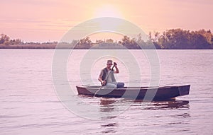 Fisherman fishing-man catching fish at sunset