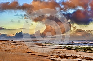 Fisherman with fishing rod on the beach