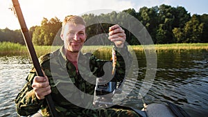 Fisherman fishing rod to fish on the lake from boat