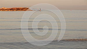 A fisherman is fishing in the sea at dawn, A fisherman on the rock against dawn sky, Silhouettes of fishermen with