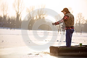 Fisherman fishing on sunny day