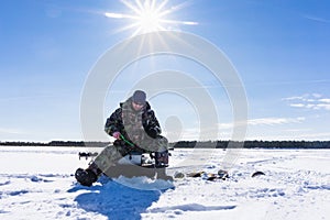 Fisherman fishing winter fishing on a bright Sunny day