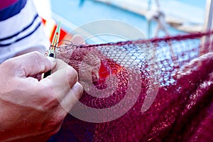 Fisherman is fixing the fish net