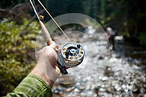 Fisherman fly fishing in the Piney River, Colorado