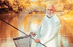 Fisherman in formal suit. Real happiness. Fishing background. Retirement fishery. Perfect weekend. Cheerful mature