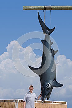 Fisherman with giant mako shark catch