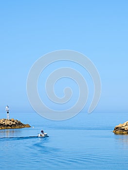 A fisherman is going fishing on a boat to the sea.