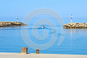 A fisherman is going fishing on a boat to the sea.