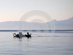 Fisherman Hauling in Net